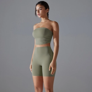 Detail of olive green seamless yoga set featuring ruched crop top and high waist shorts