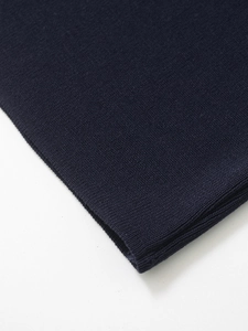 Detailed view of dark blue fine knit fabric texture with uniform stitching details