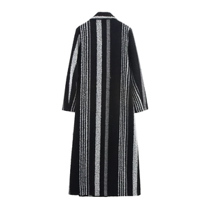 Back view of a long black and white striped wool coat with textured boucle fabric