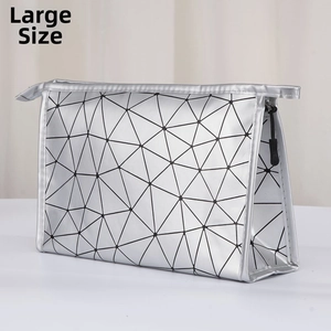 Macro shot of large silver geometric cosmetic bag with black triangular mesh design