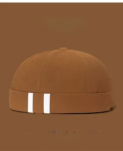 Detail showing side white stripes on brown cotton skull cap with 9 color swatches