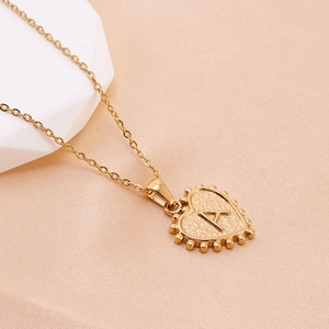 Golden heart-shaped stainless steel necklace with hammered texture and letter A pendant