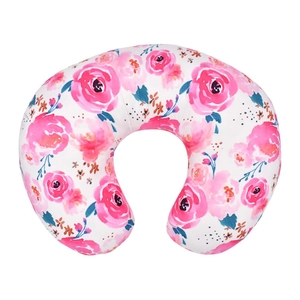 Close-up of baby nursing pillow cover with pink rose floral print on soft white fabric