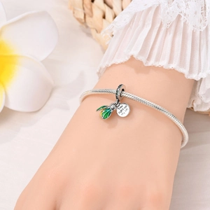 Detail of silver firefly charm with You light up my life engraving on snake chain bracelet