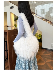Detailed back view of a person wearing the white faux fur large shoulder bag