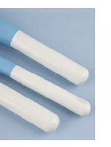 Macro view of light blue lacquered solid wood makeup brush handles with smooth finish