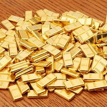 Detailed close-up of multiple stacked golden bars with 999.9 purity engraving on wood