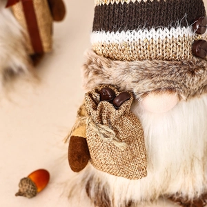 Detail of coffee gnome with sequined knit hat and faux fur beard holding bean sack