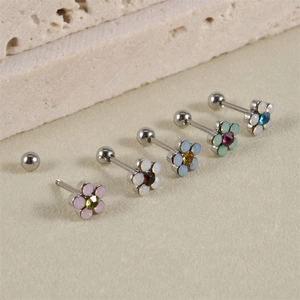 Detail of colorful floral cartilage studs with screw ball back in polished steel