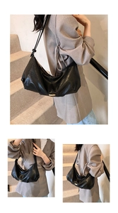 Close-up detail of black matte PU leather dumpling bag with elegant pleats and gold hardware