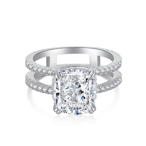 Macro shot of cushion-cut diamond ring featuring a dual-row pavé band in 925 silver