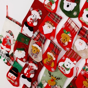 Detailed assortment of small Christmas stockings featuring Santa, snowman, and reindeer designs