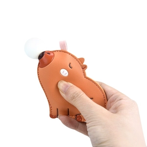 Squeezable cartoon capybara keychain in orange PU leather with bubble-blowing feature