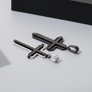 Close-up of dual-layer stainless steel cross pendants in black and silver finishes