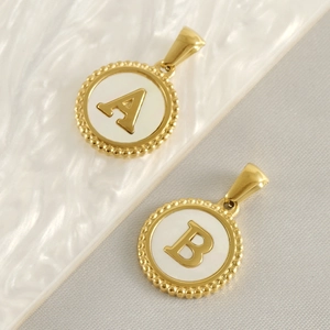 Detail showing 18K gold stainless steel A and B letter pendants with white shell inlay