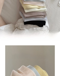 Detail of ribbed knit texture on pastel colored silk blend cotton socks in light blue