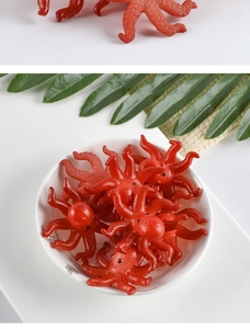 Realistic red PVC octopus keychain pendant in white bowl with green leaf detail