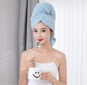 Detail of light blue waffle texture coral fleece hair drying towel worn by a model