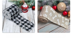 Close-up of dog paw and bone patterned ribbons on festive wooden background decoration