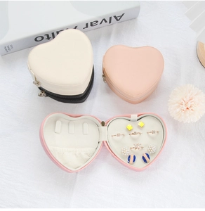 Detail view of heart-shaped PU leather jewelry box in white, black and pink options