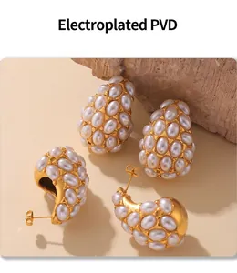 Macro shot of PVD gold plated earrings with white pearls and clustered droplet design