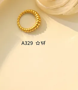 Detailed view of the twisted croissant gold-plated ring with ribbed texture and glossy finish
