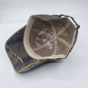 Detail view of camouflage baseball cap interior with sweatband and adjustable metal buckle