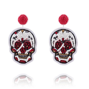 Macro detail of Sugar Skull beaded earrings with intricate red and black embroidery work