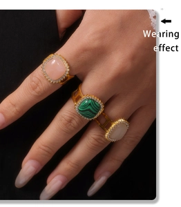 Wearing effect of gold rings with pink, malachite green, and opal-like stones