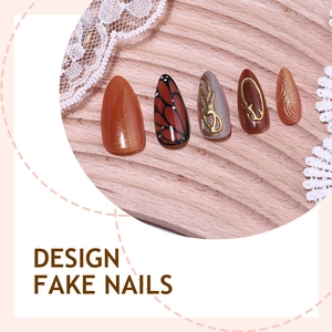 3D butterfly press-on nails with amber glitter and gold relief on wood tray