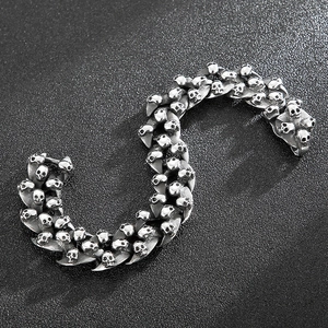 Close-up of vintage skull bracelet in aged silver finish with detailed gothic engravings
