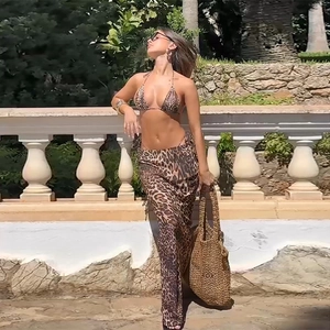 Outdoor shot of leopard print three-piece bikini set with matching beach skirt cover-up