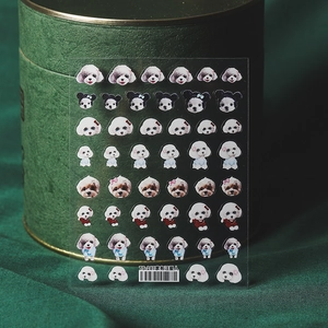 3D cute dog cartoon nail stickers with poodle patterns on a dark green gift box