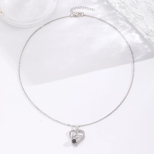 Close-up of heart-shaped MOM necklace with projection stone and I LOVE YOU engraving