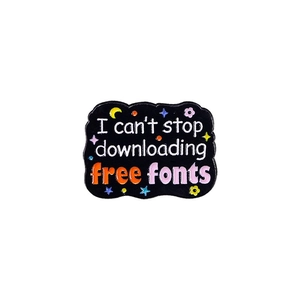 Detail of enamel brooch with 'I can't stop downloading free fonts' text and stars