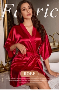 Detailed view of red satin robe fabric with silky texture and elegant belted design