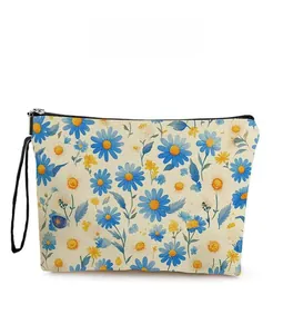 Detailed pattern display of blue daisy floral print on canvas cosmetic bag with black zipper