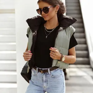 Green quilted puffer vest with stand collar and zipper, styled with jeans and sunglasses