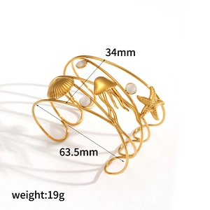 Ocean style stainless steel cuff bracelet with shell and starfish charms, 63.5mm diameter