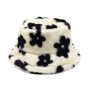 Winter plush bucket hat featuring black floral patterns on off-white faux fur material