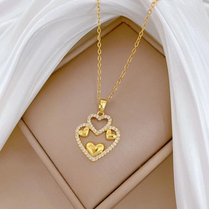 Elegant gold double heart necklace with crystal inlay on a silk jewelry gift box