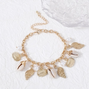 Detail of vintage Baroque bracelet featuring gold shells, conches, and white pearls