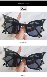 Detail view of black bat-wing cat eye sunglasses with silver stars and crystal rhinestones
