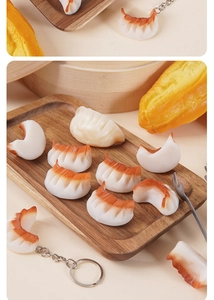 Macro view of realistic PVC dumpling models with gradient colors on a wooden tray