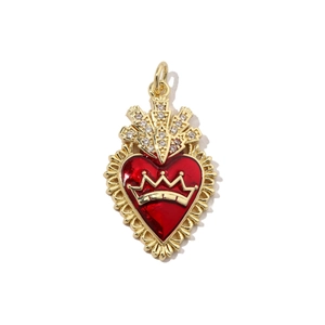Detailed macro of red enamel heart pendant with golden crown and white cubic zirconia