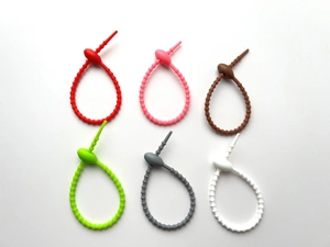 Top view of colorful silicone cable ties in red pink green grey and white colors