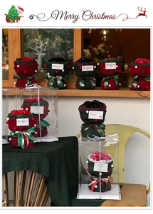 Detail of Christmas bouquets with plush balls and festive ribbons in gift packaging