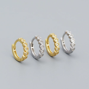 Pair of gold and silver S925 heart shaped huggie hoop earrings with sparkling cubic zirconia