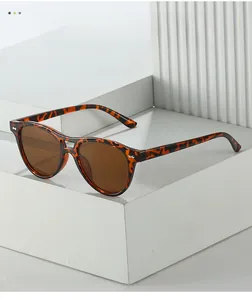 Close-up of tortoise shell frame sunglasses with dark brown lenses and metal rivets