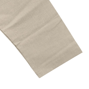 Detail shot of light khaki linen fabric showing double-needle stitching and fine texture